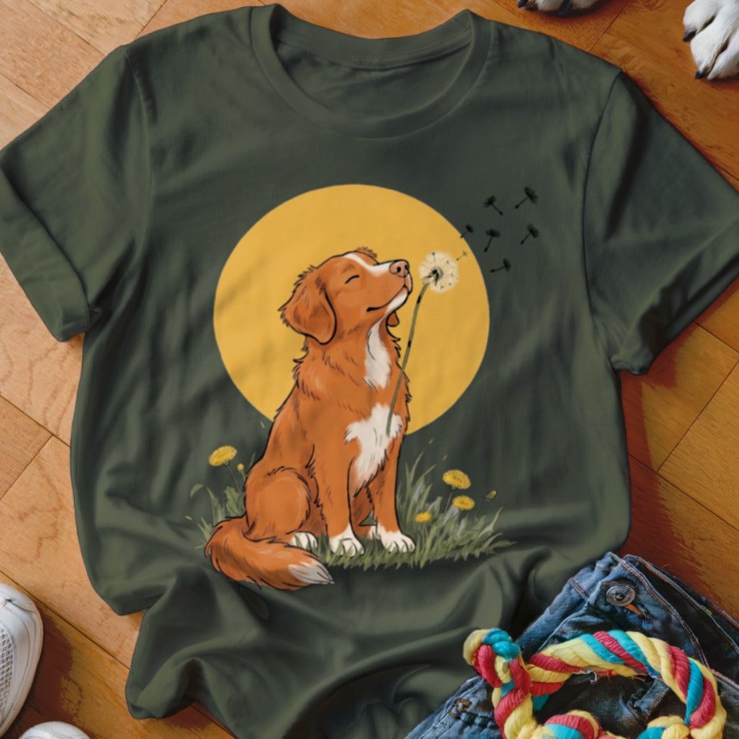 Dark green t-shirt featuring an illustration of a brown and white dog blowing a dandelion.