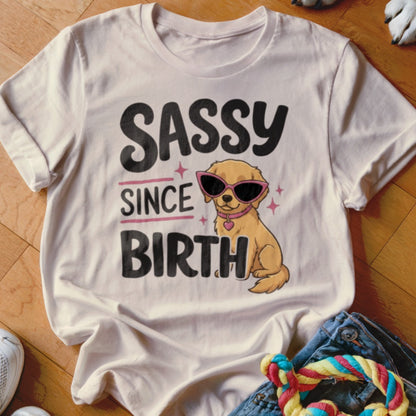 Cream t-shirt with "SASSY SINCE BIRTH" text and a golden retriever wearing sunglasses.