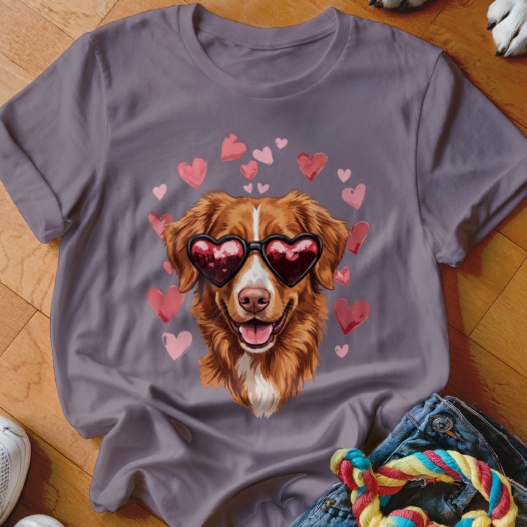 A gray t-shirt features a graphic of a golden retriever wearing heart-shaped sunglasses surrounded by floating pink hearts.