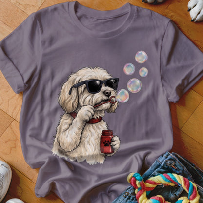 A gray t-shirt featuring a graphic of a white dog wearing sunglasses and blowing bubbles.