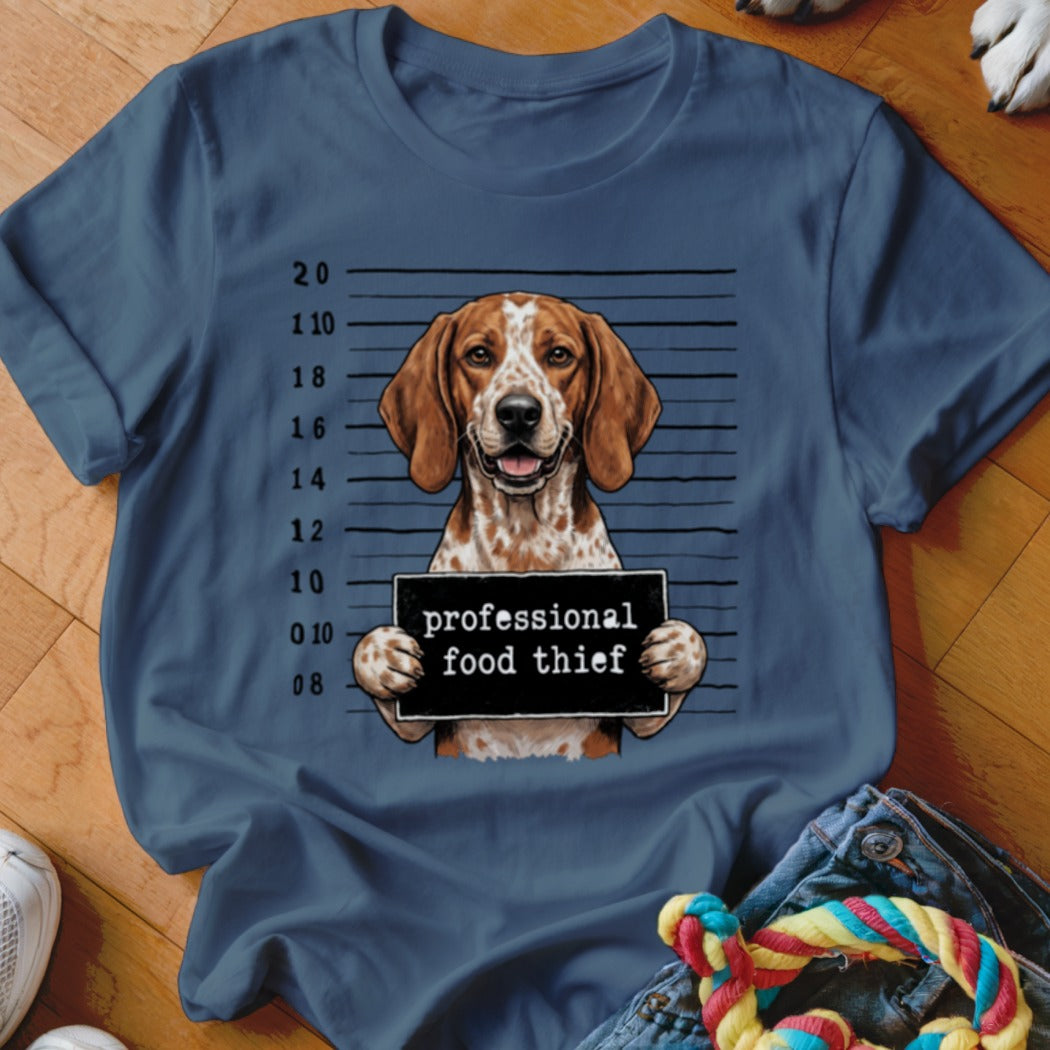 Hound dog in mugshot with sign reading "professional food thief".