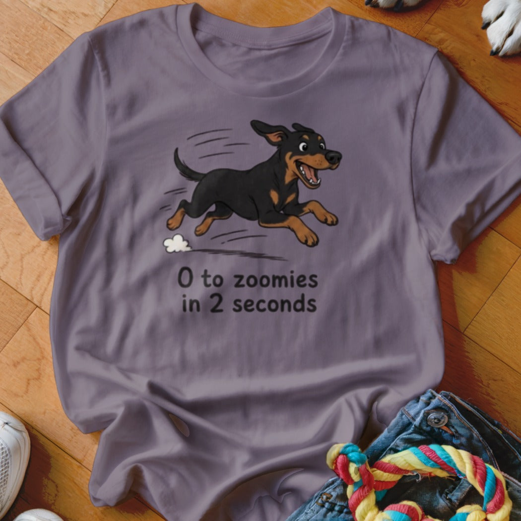 Purple t-shirt with cartoon dog running and text "0 to zoomies in 2 seconds".