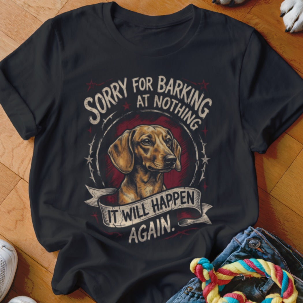 A black t-shirt printed with a dachshund illustration and the text Sorry for barking at nothing, it will happen again.