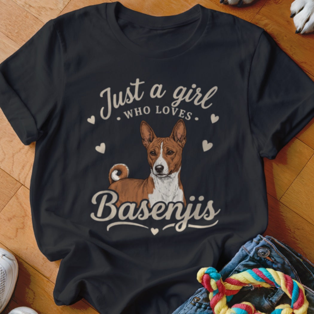 A black crewneck t-shirt featuring the text Just a girl who loves Basenjis surrounding a Basenji illustration.