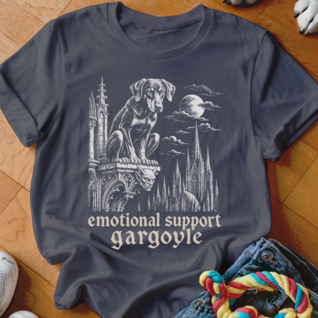Dark t-shirt with a graphic of a dog sitting on a gargoyle above gothic architecture at night.