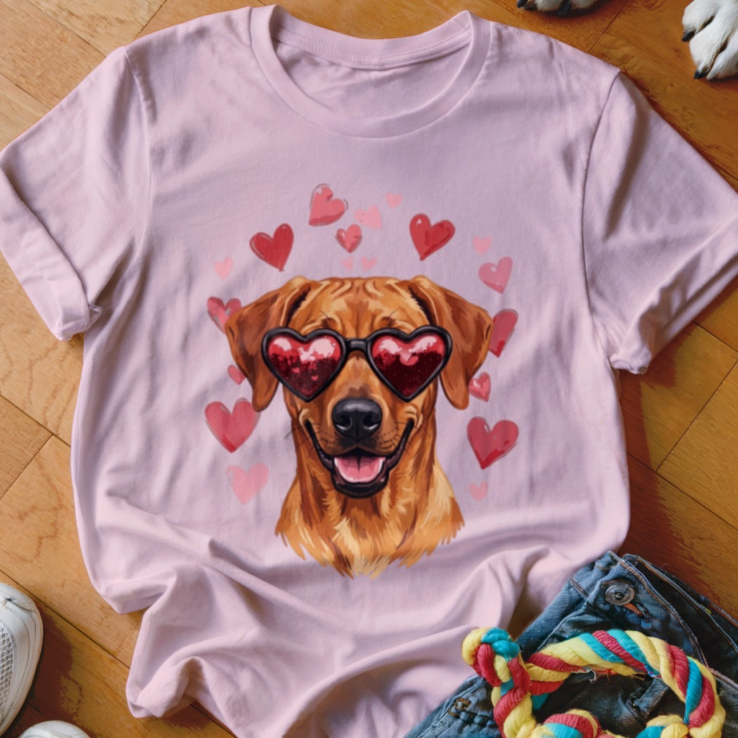 Pink t-shirt featuring a golden retriever wearing heart-shaped sunglasses surrounded by floating red hearts.
