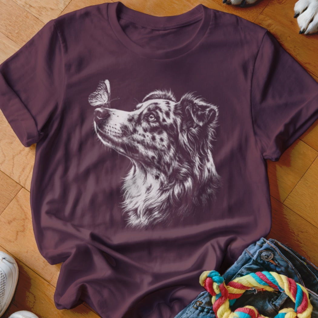 Maroon crewneck t-shirt featuring a white line drawing of an Australian Shepherd looking at a butterfly.