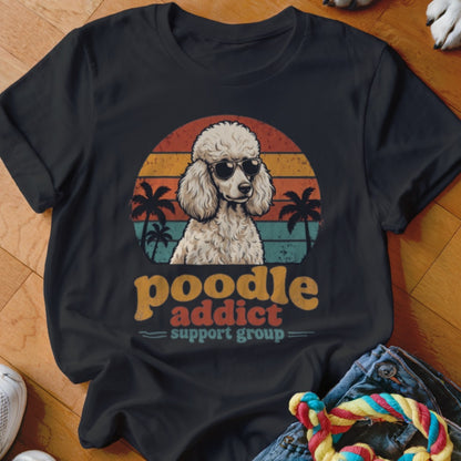 Black t-shirt featuring a retro graphic of a poodle in sunglasses with sunset and palm trees.