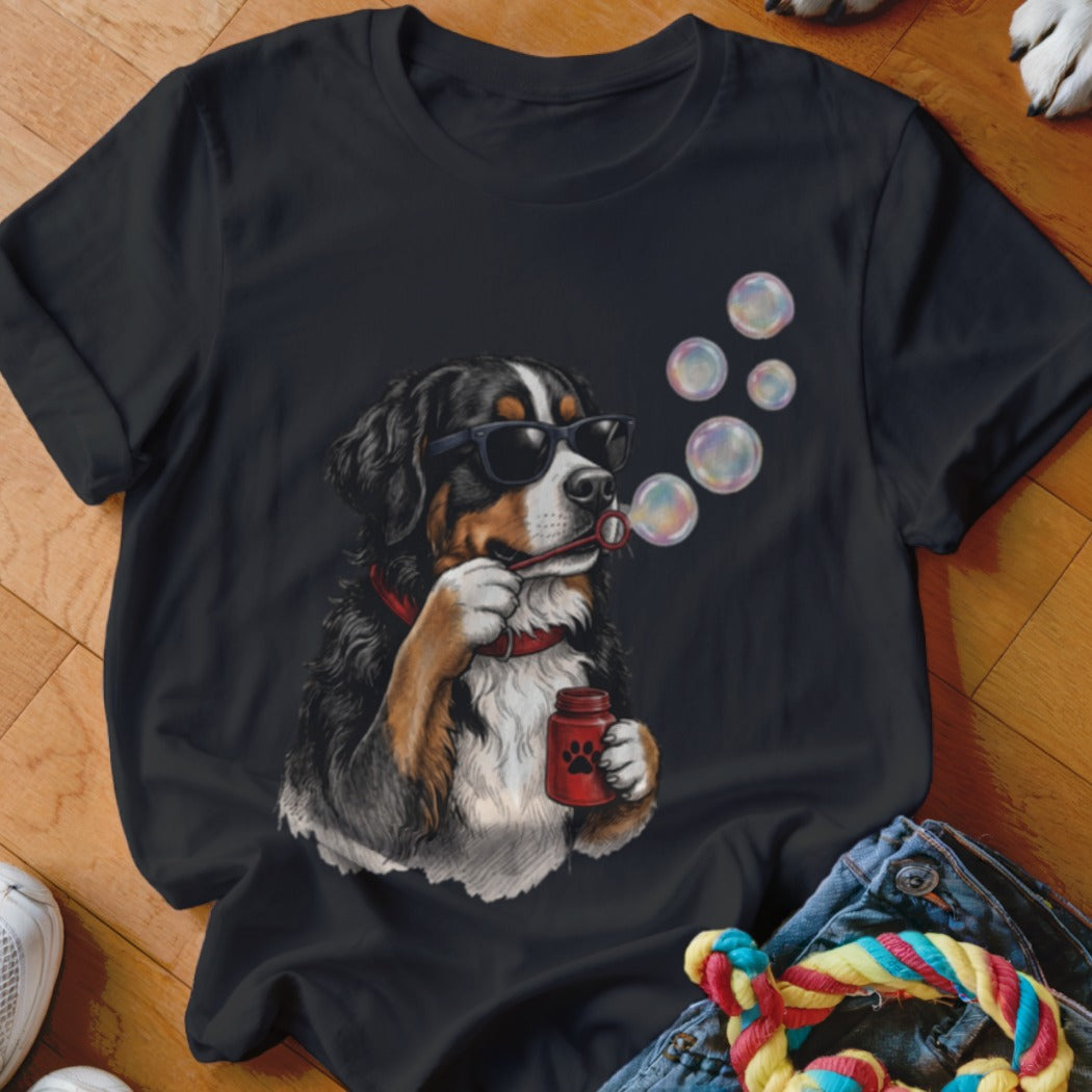 Black t-shirt featuring a graphic of a Bernese Mountain Dog wearing sunglasses and blowing soap bubbles.