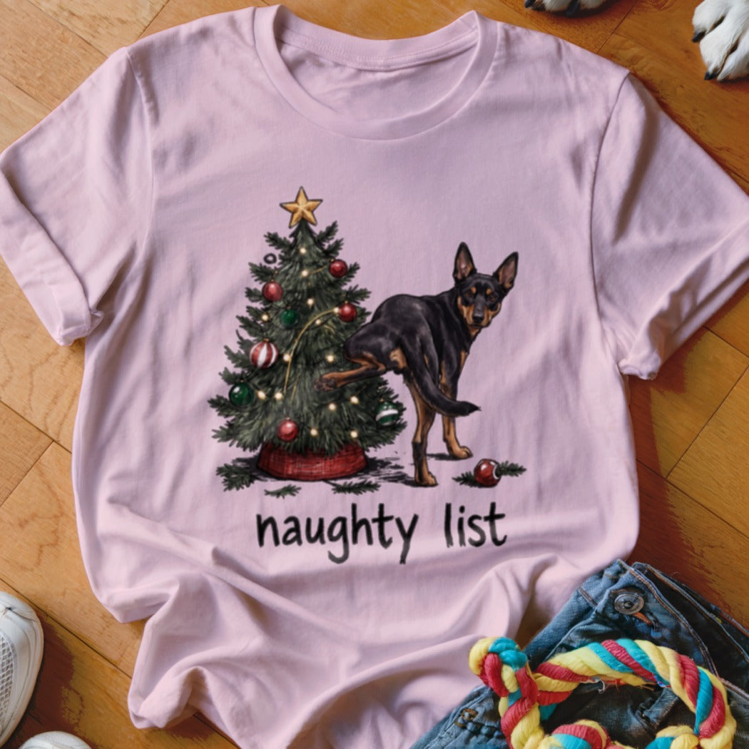 Pink t-shirt with a dog lifting its leg on a Christmas tree, text reads "naughty list".