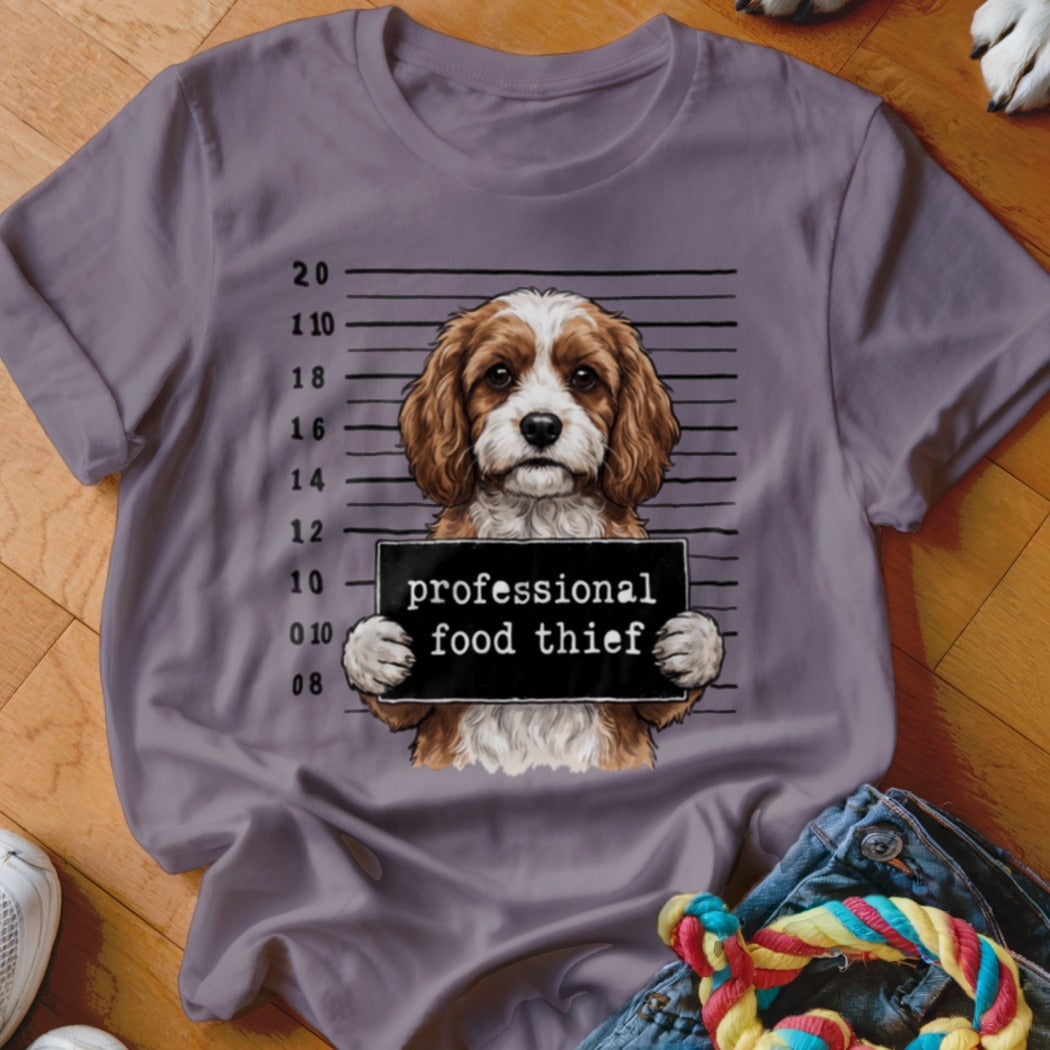 Dog mugshot graphic with text "professional food thief" on a t-shirt.