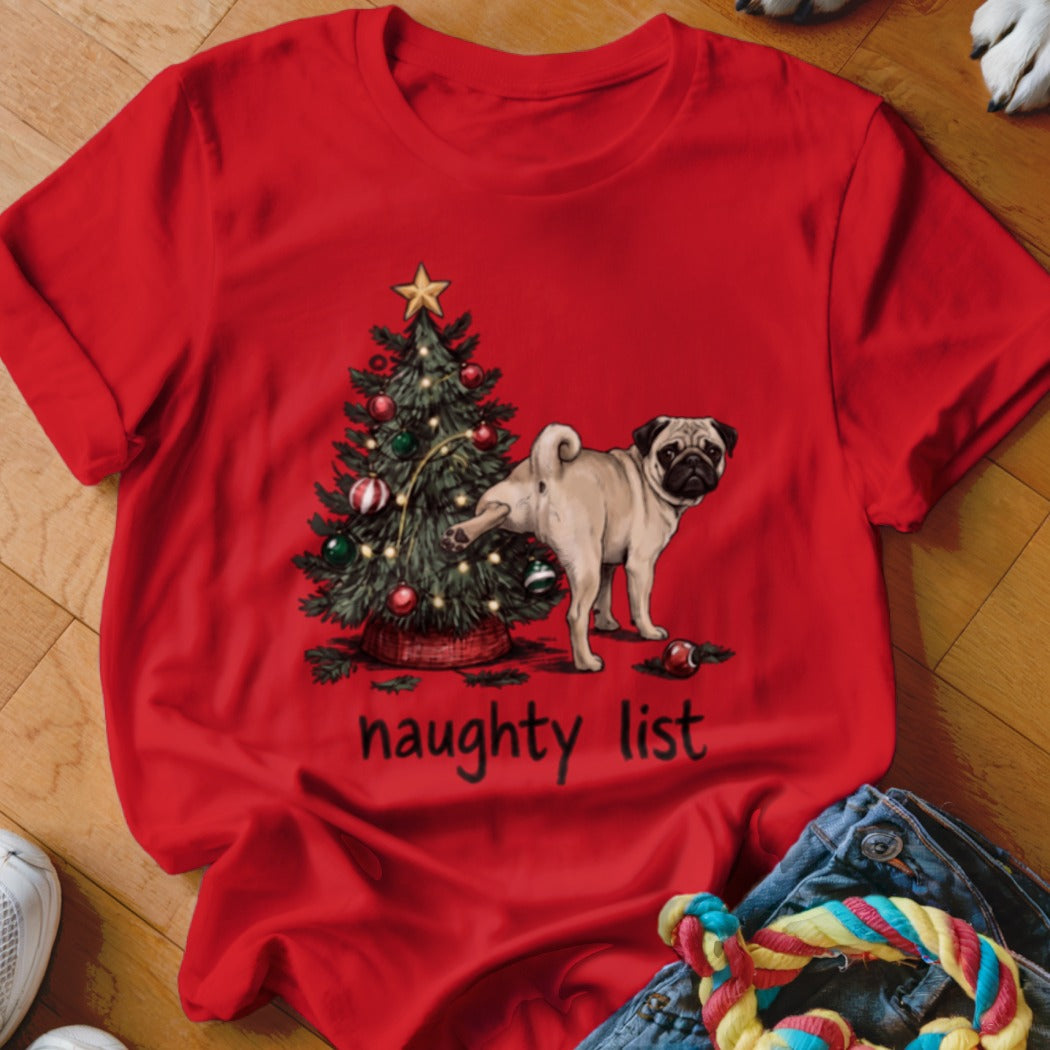 A red t-shirt printed with a pug lifting its leg against a Christmas tree above the words naughty list.