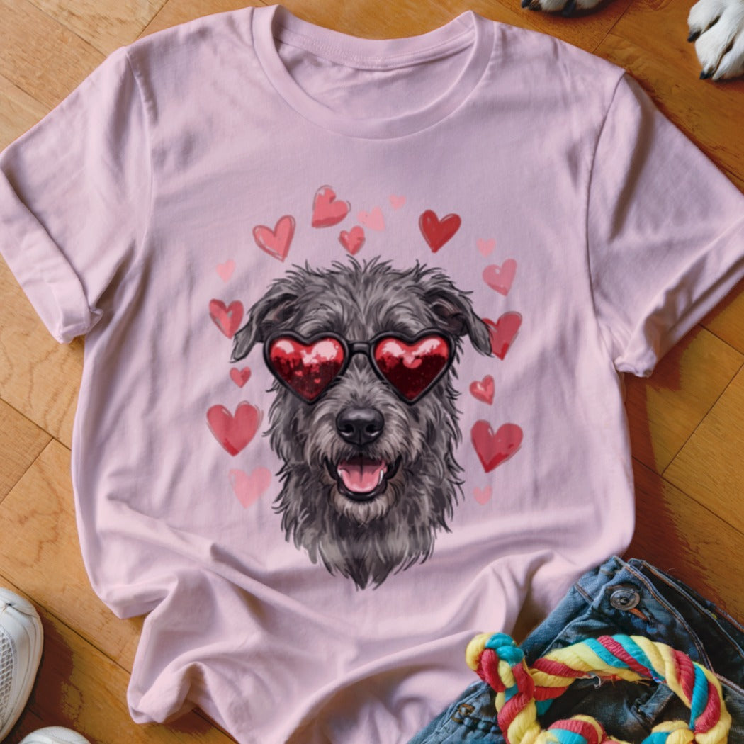 Light pink t-shirt featuring a graphic of a scruffy dog wearing heart-shaped sunglasses surrounded by pink hearts.
