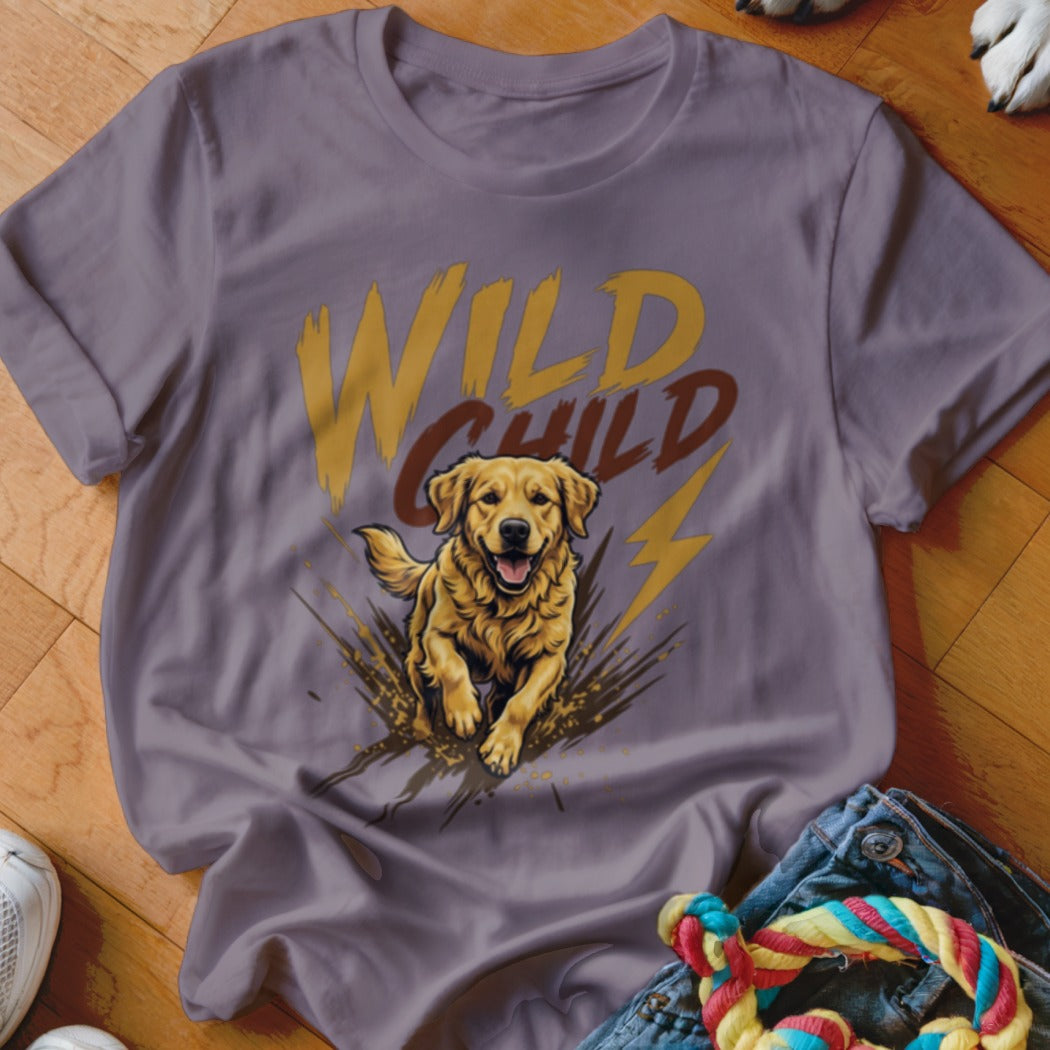 A mauve t-shirt with a graphic of a golden retriever jumping through mud, with the text Wild Child.