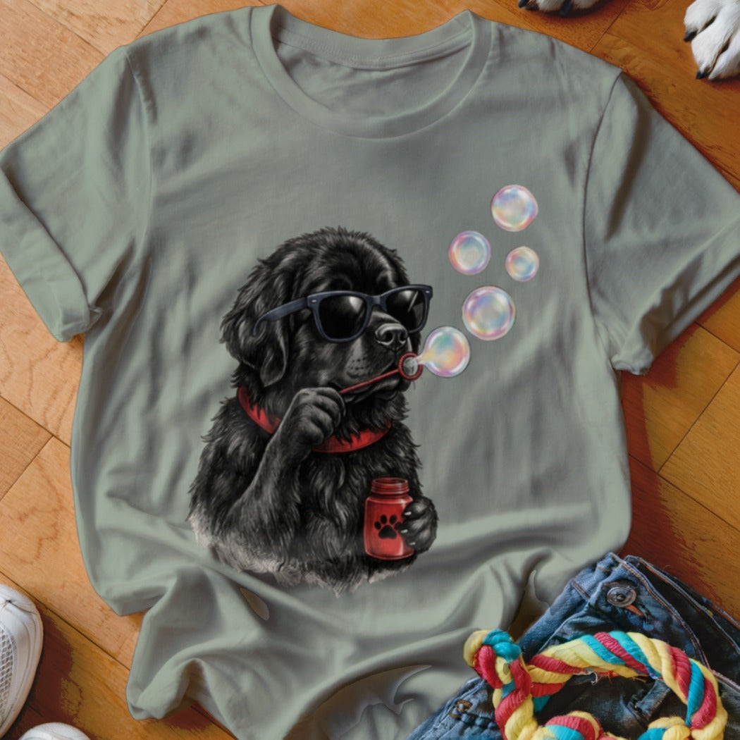 Sage green crewneck t-shirt featuring a graphic of a black dog wearing sunglasses and blowing bubbles.