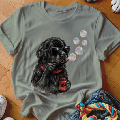 Sage green crewneck t-shirt featuring a graphic of a black dog wearing sunglasses and blowing bubbles.