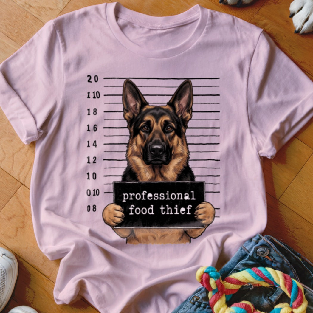German Shepherd mugshot with "professional food thief" sign.