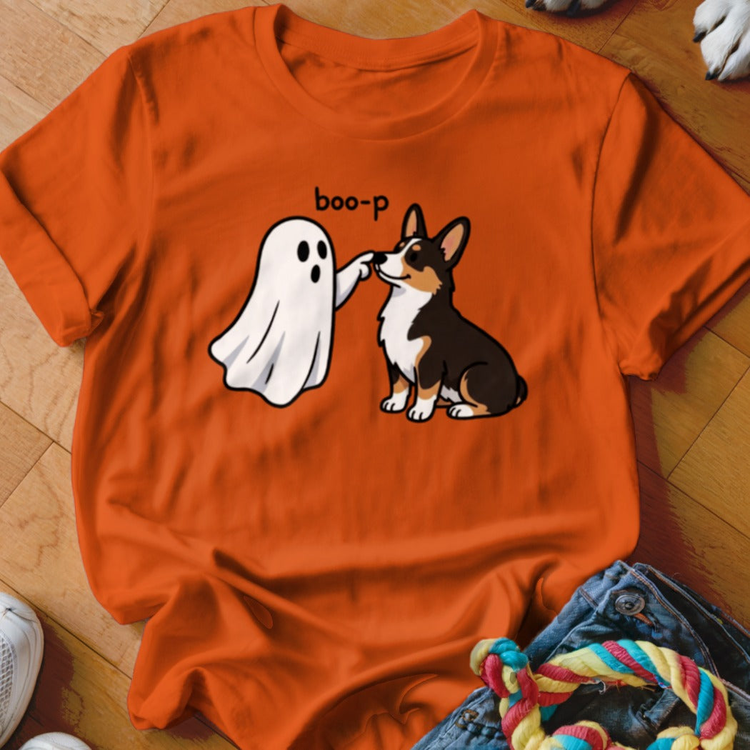 A ghost booping a corgi with the text "boo-p" on an orange shirt.
