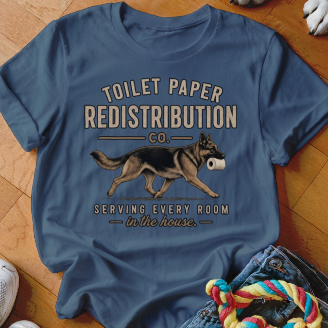 German Shepherd with toilet paper in mouth on navy blue shirt.
