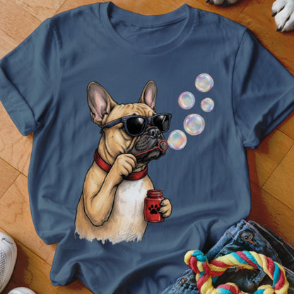 A dark blue t-shirt printed with a graphic of a French Bulldog wearing sunglasses and blowing soap bubbles.