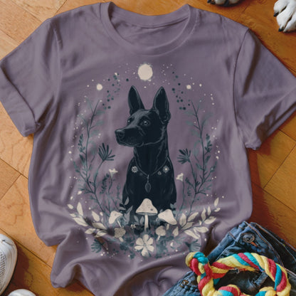Black dog surrounded by mystical forest elements and moon on a purple t-shirt.