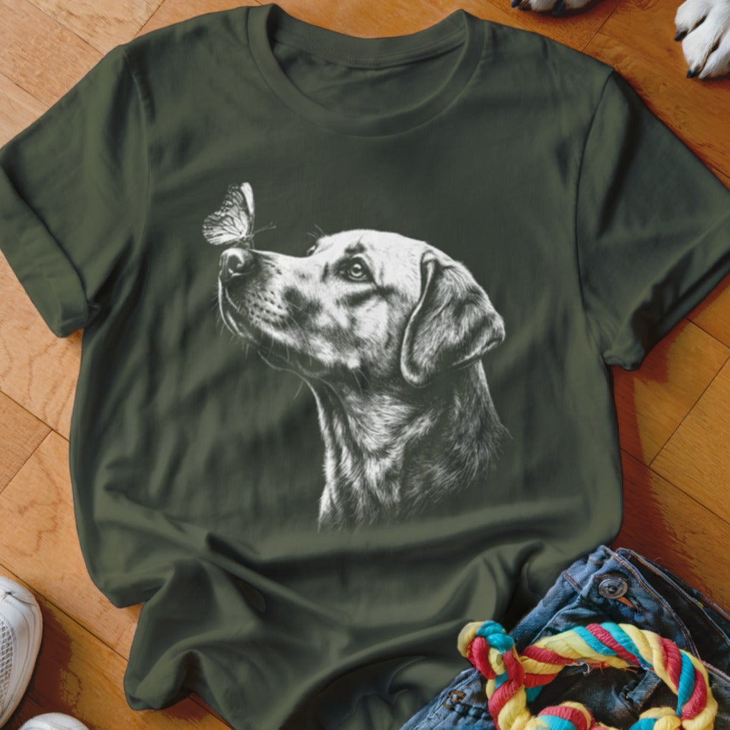Dark green short-sleeved t-shirt featuring a white sketched graphic of a dog looking at a butterfly.