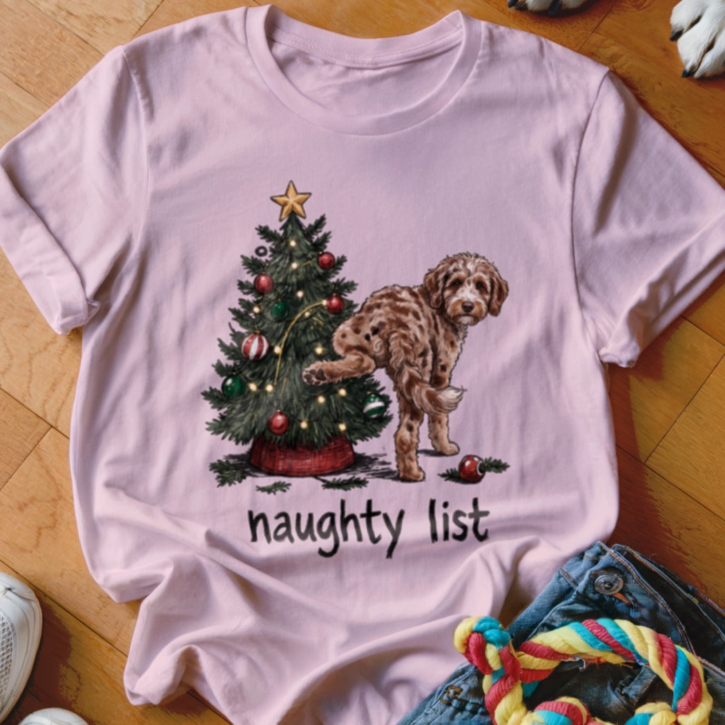Pink t-shirt with a Christmas tree and a dog on the naughty list.