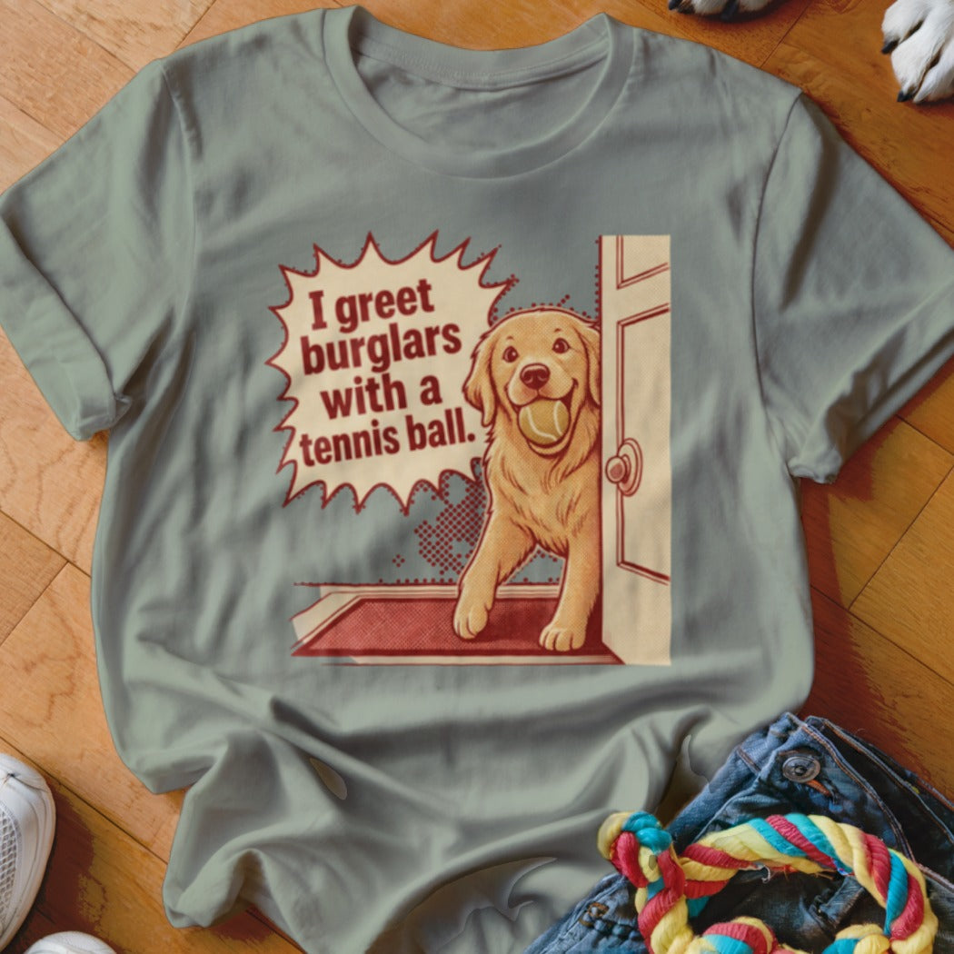 Golden retriever at an open door with a tennis ball and text "I greet burglars with a tennis ball."