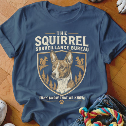 A dark blue t-shirt printed with a graphic featuring a dog and text reading The Squirrel Surveillance Bureau.
