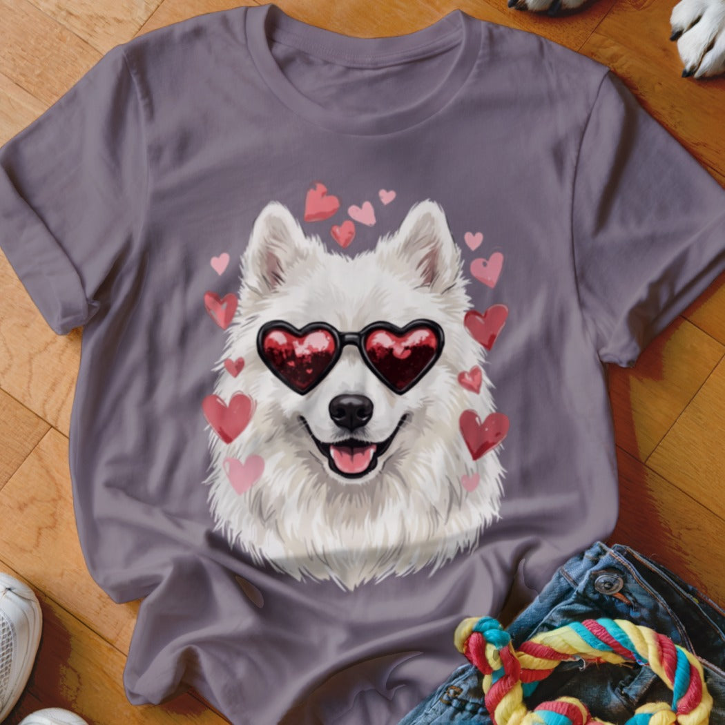 A mauve t-shirt features a graphic of a white Samoyed dog wearing heart-shaped sunglasses, surrounded by pink hearts.