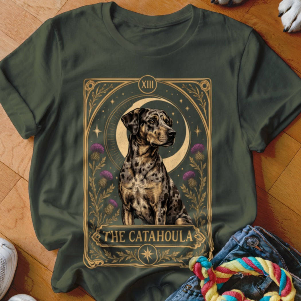 Dark green t-shirt featuring a tarot card graphic of a spotted Catahoula dog, crescent moon, and purple thistles.