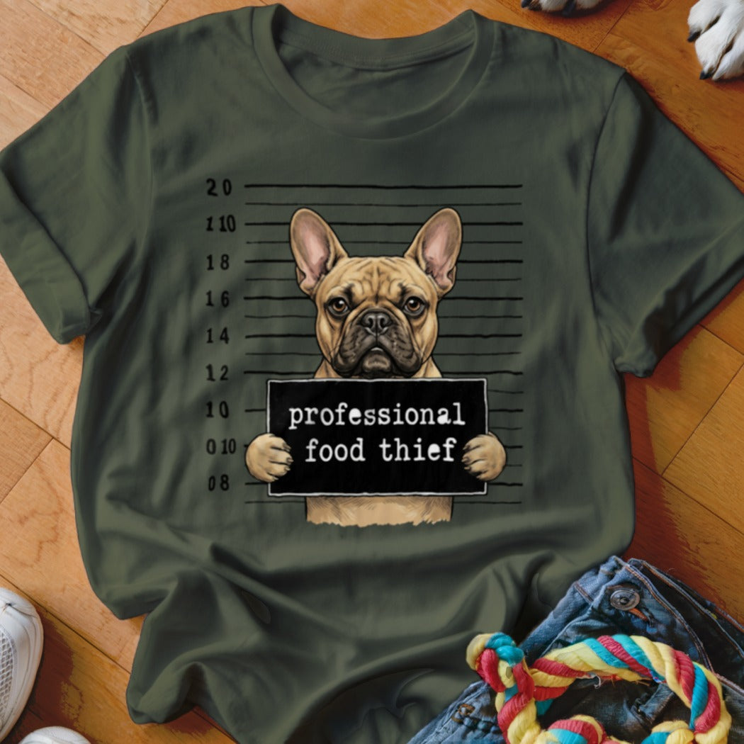 French bulldog mugshot with text "professional food thief" on a green t-shirt.