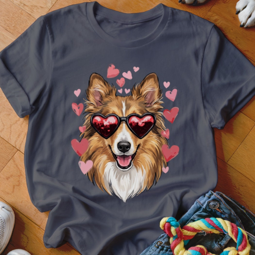 A dark gray crewneck t-shirt featuring a graphic of a smiling collie wearing heart-shaped sunglasses surrounded by pink hearts.
