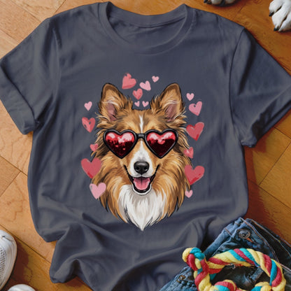 A dark gray crewneck t-shirt featuring a graphic of a smiling collie wearing heart-shaped sunglasses surrounded by pink hearts.