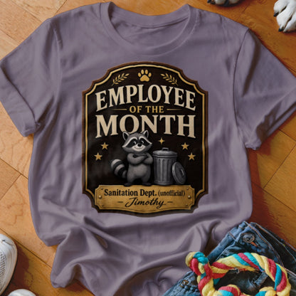 T-shirt graphic with raccoon and trash can, "Employee of the Month Sanitation Dept. (unofficial)."