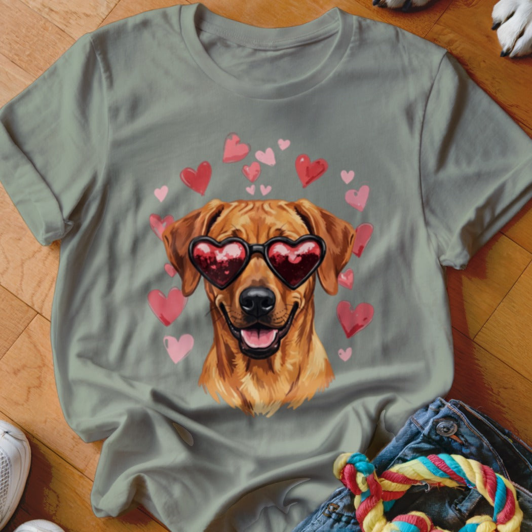 Sage green t-shirt featuring a graphic of a golden retriever wearing heart-shaped sunglasses surrounded by pink hearts.