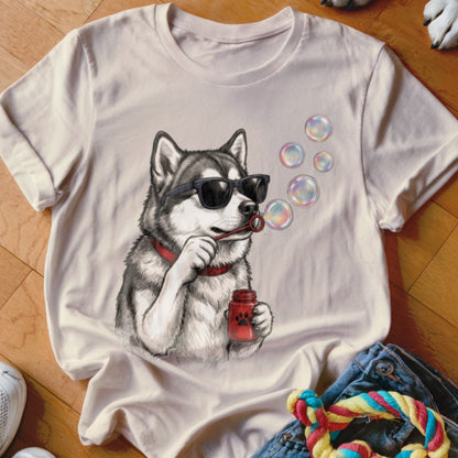 A light pink crewneck t-shirt featuring a graphic of a husky wearing sunglasses and blowing bubbles.