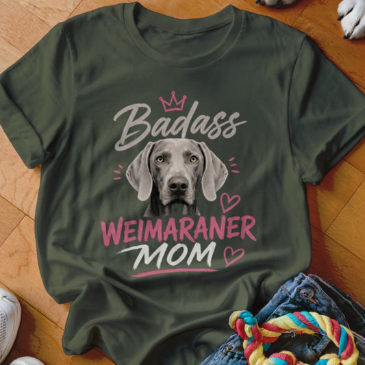Weimaraner dog face with text "Badass WEIMARANER MOM" on a green shirt.