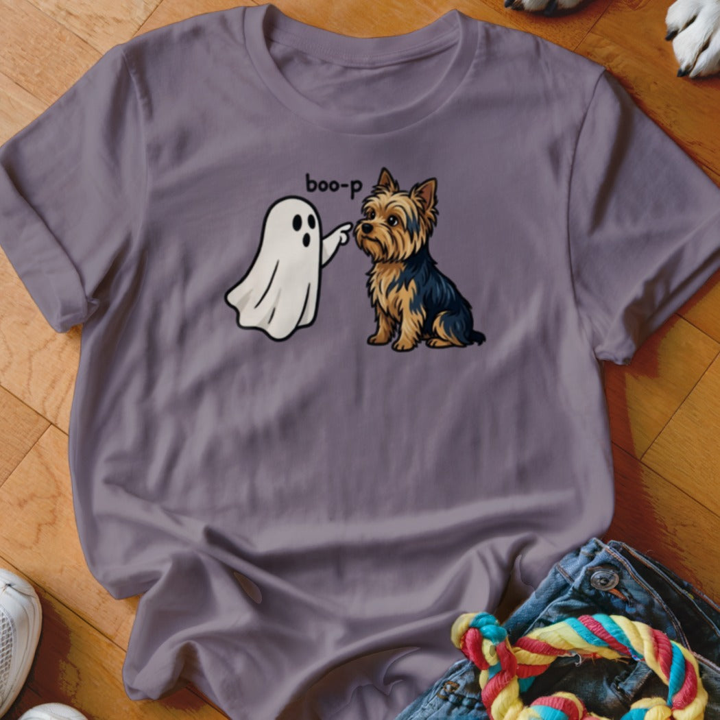 Yorkshire Terrier sits while a ghost says "boo-p" and touches its nose.