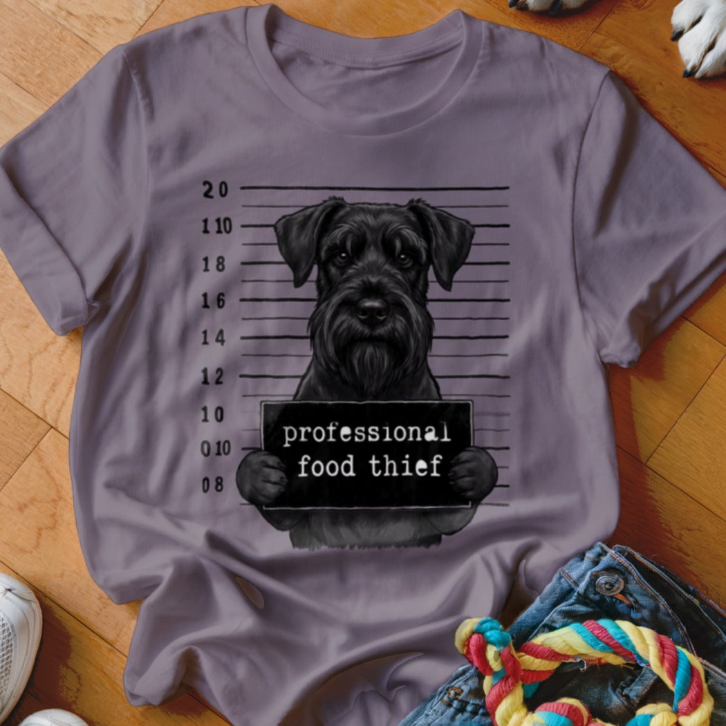 Black schnauzer mugshot with "professional food thief" sign and measurement lines.