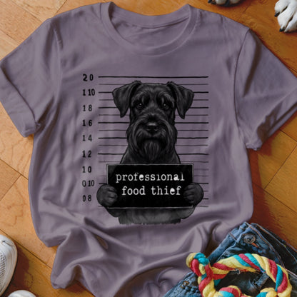 Black schnauzer mugshot with "professional food thief" sign and measurement lines.