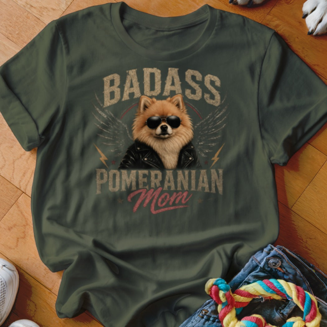 Green t-shirt with graphic of Pomeranian dog wearing sunglasses and leather jacket, text "Badass Pomeranian Mom".