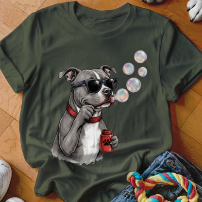 An olive green t-shirt featuring a graphic of a pit bull wearing sunglasses and blowing bubbles.