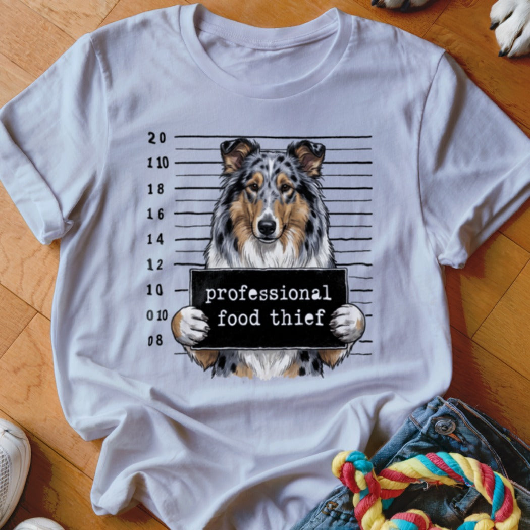 White t-shirt with a dog in front of a police lineup holding a sign that says "professional food thief".