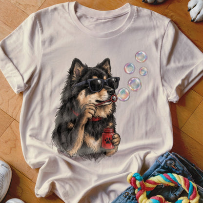 A light pink t-shirt featuring a graphic of a black and tan dog wearing sunglasses and blowing bubbles.