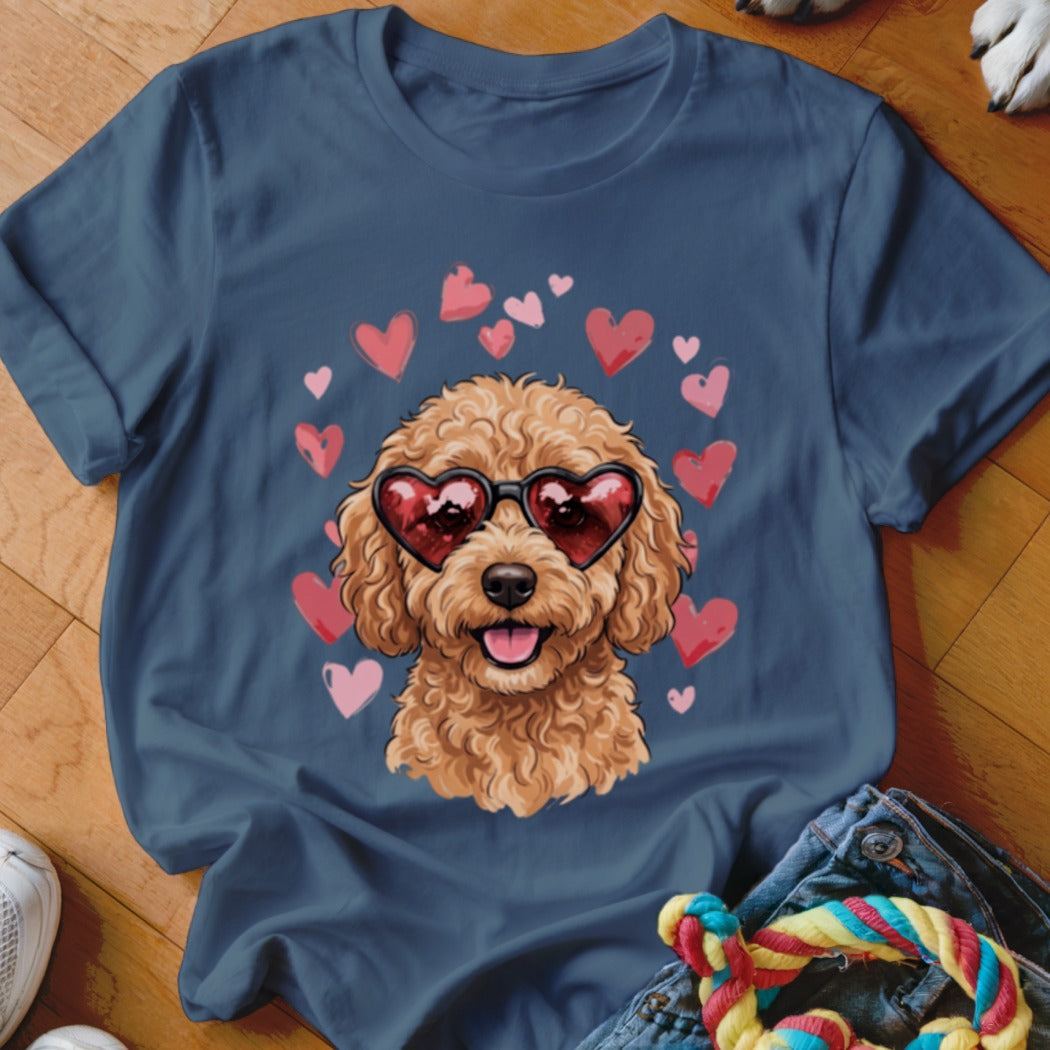 A dark blue t-shirt printed with a fluffy poodle wearing heart sunglasses surrounded by pink hearts.