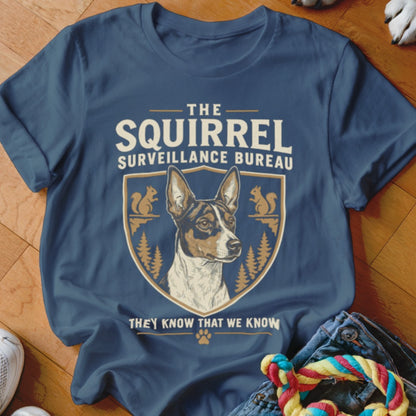 Dark blue t-shirt featuring a crest with a dog, squirrels, and the text The Squirrel Surveillance Bureau.