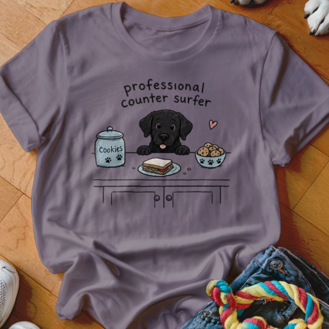 Black lab puppy cartoon with text "professional counter surfer," cookies, and sandwich.