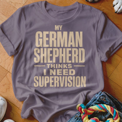 Purple t-shirt with text: MY GERMAN SHEPHERD THINKS I NEED SUPERVISION.