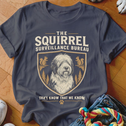 Dark grey t-shirt featuring a graphic that reads The Squirrel Surveillance Bureau and an Old English Sheepdog illustration inside a shield emblem.